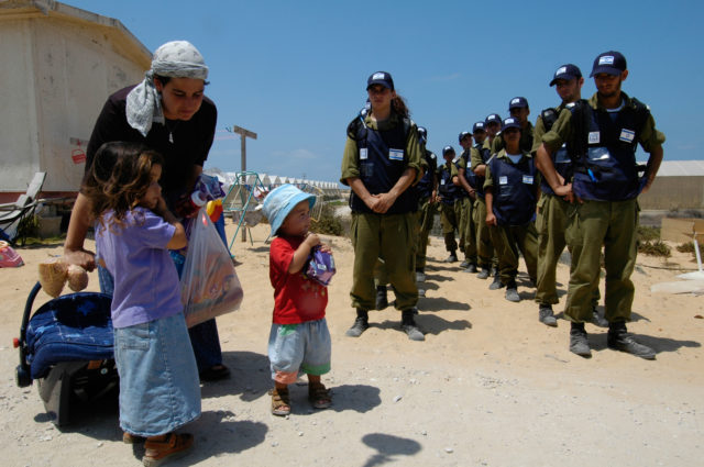 Lines of Israeli soldiers wait to remove settlers from the Tel Katifa Jewish settlement as part of the Israeli disengagement from Gaza strip
