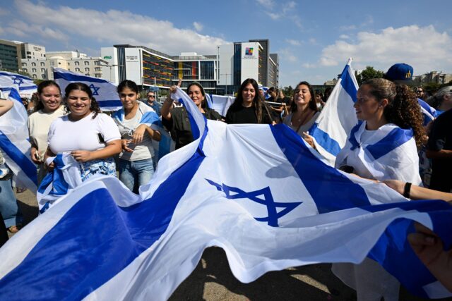Petah Tikva, Israel. 13th Oct, 2025. People arrive at Beilinson Hospital to welcome five of the twenty hostages who were released from Hamas captivity as part of the deal to end the war. The people of Israel celebrated the release of the hostages after tw