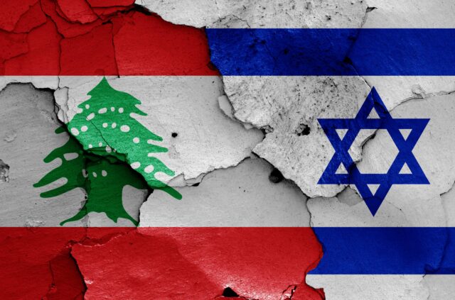 flags of Lebanon and Israel painted on cracked wall