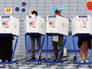 Voters fill in their ballots at a polling station in New York City.