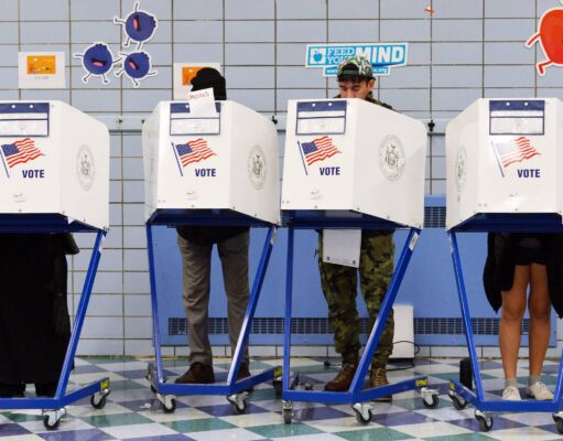 Most Americans Still Believe in Land of Opportunity, Far Fewer Support Capitalism Voters fill in their ballots at a polling station in New York City.